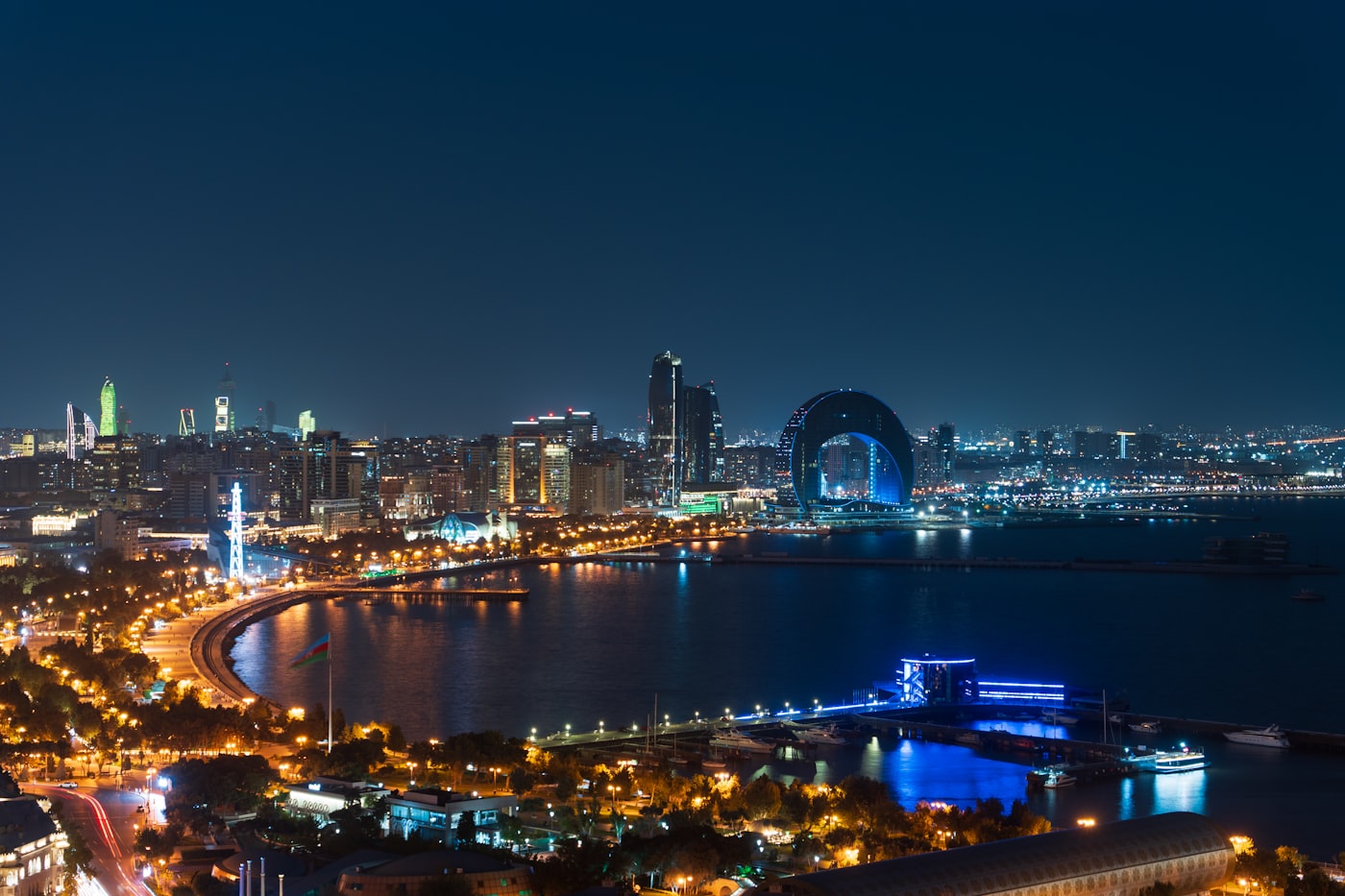 Baku skyline glowing over the Caspian Sea at night